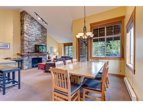 101C - 47 Rivermount Place, Fernie, BC - Indoor Photo Showing Dining Room With Fireplace
