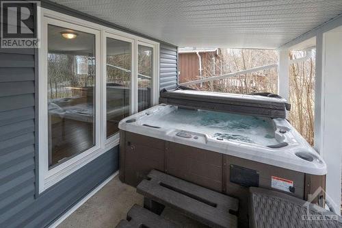 Take time to relax in this hot tub under the porch roof (stay dry from the rain and snow)installed in 2022. - 171 Gardiner Shore Road, Carleton Place, ON - Outdoor With Deck Patio Veranda With Exterior