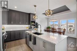 Very functional kitchen with stunning design complete with quartz countertops and upgraded fixtures. - 