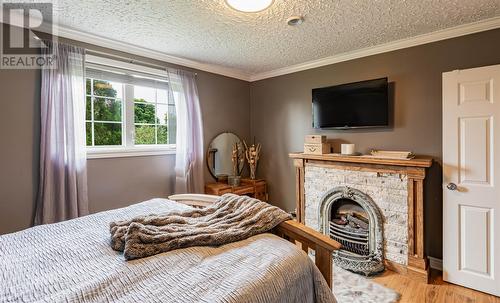 1498 Torbay Road, Torbay, NL - Indoor Photo Showing Bedroom With Fireplace
