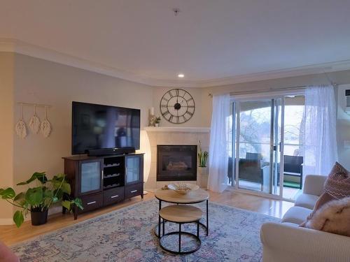 306-1966 Enterprise Way, Kelowna, BC - Indoor Photo Showing Living Room With Fireplace