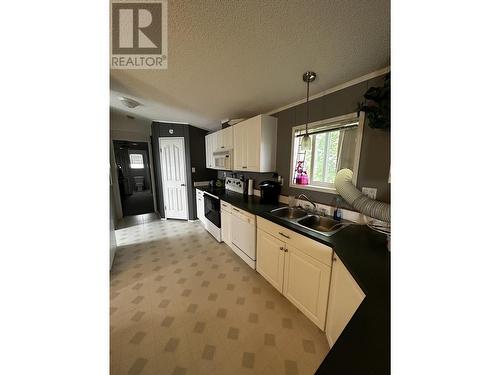 51 5701 Airport Drive, Fort Nelson, BC - Indoor Photo Showing Kitchen With Double Sink