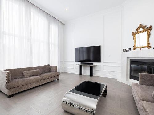 Mezzanine - 12 Rue Pierre-Trudeau, Dollard-Des-Ormeaux, QC - Indoor Photo Showing Living Room With Fireplace