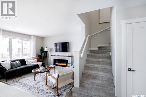 206 Schmeiser Bend, Saskatoon, SK - Indoor Photo Showing Living Room With Fireplace