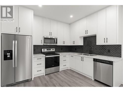 5667 Jasper Way, Kelowna, BC - Indoor Photo Showing Kitchen With Double Sink