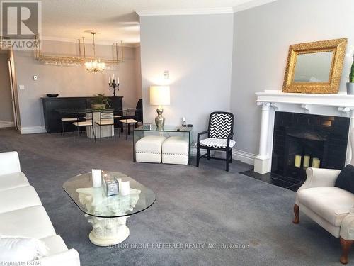 #307 -460 Wellington St, London, ON - Indoor Photo Showing Living Room With Fireplace