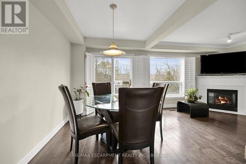 #10 -2151 Walkers Line, Burlington, ON - Indoor Photo Showing Dining Room With Fireplace