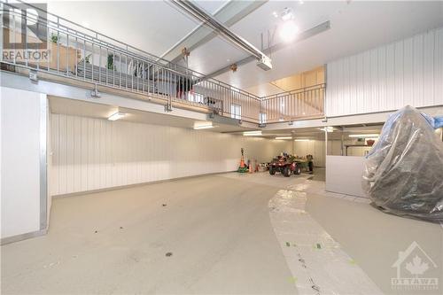 3000 sq ft 3 level workshop with lift, fits 4 to 5 vehicles - 6780 Pilon Point Road, Summerstown, ON - Indoor Photo Showing Garage