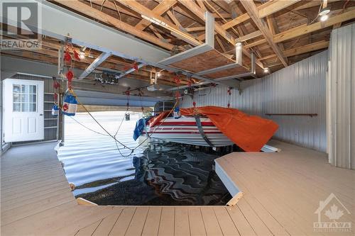 Double slip boathouse with lifts - 6780 Pilon Point Road, Summerstown, ON - Indoor Photo Showing Garage