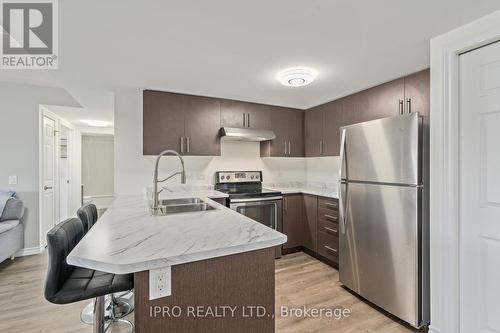 #413 -7 Kay Cres, Guelph, ON - Indoor Photo Showing Kitchen With Stainless Steel Kitchen With Double Sink With Upgraded Kitchen
