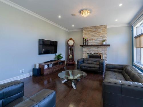 Salle familiale - 7845 Rue De Liverpool, Brossard, QC - Indoor Photo Showing Living Room With Fireplace