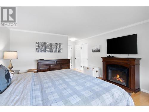 704 Moss Street, Revelstoke, BC - Indoor Photo Showing Bedroom With Fireplace