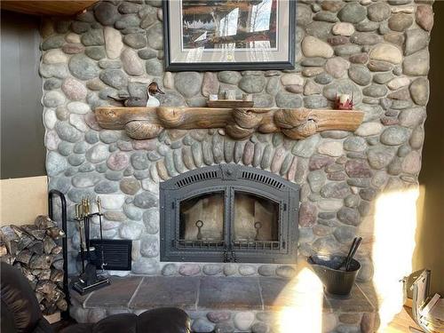 129 South Bay Drive, Onanole, MB - Indoor Photo Showing Living Room With Fireplace