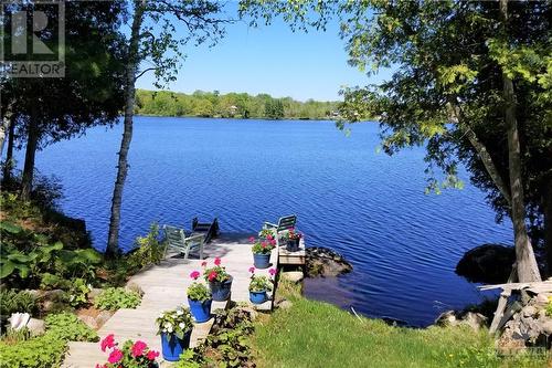 Gradual slope , easy step down to the waterfront and four season dock. - 154 Bluff Point Drive, Calabogie, ON - Outdoor With Body Of Water With View