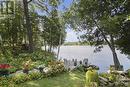 The lower dock is fixed, not a seasonal removal and is always a lovely spot to enjoy quiet leisure time or greet guests pulling up by boat. - 154 Bluff Point Drive, Calabogie, ON  - Outdoor With Body Of Water With View 
