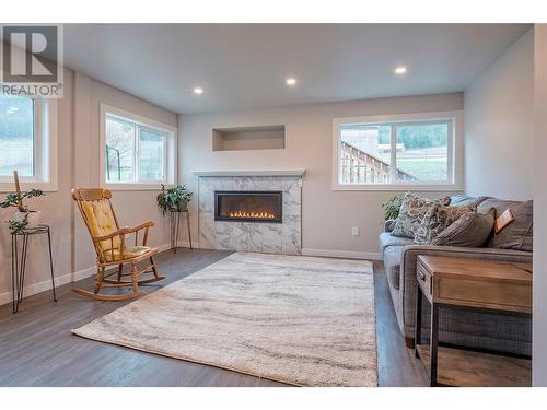 6449 97 Highway, Falkland, BC - Indoor Photo Showing Living Room With Fireplace