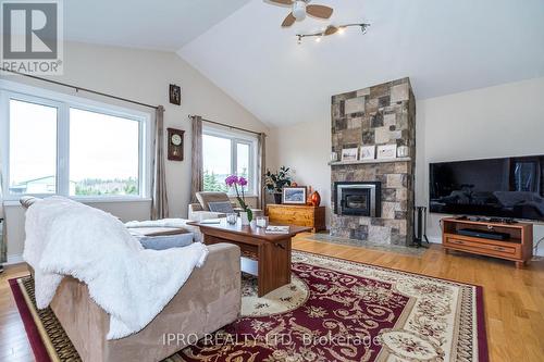 434424 4 Line, Amaranth, ON - Indoor Photo Showing Living Room With Fireplace