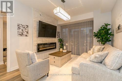 B315 - 271 Sea Ray Avenue, Innisfil, ON - Indoor Photo Showing Living Room With Fireplace