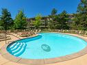 402-1960 Enterprise Way, Kelowna, BC  - Outdoor With In Ground Pool With Backyard 