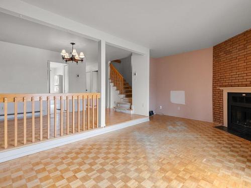 Living room - 6055 Av. Tisserand, Brossard, QC - Indoor With Fireplace