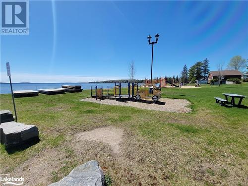 Walk to the lake - splash pad, playground, boat launch, and picnic area. - 13 Main Street, Sundridge, ON - Outdoor With Body Of Water With View