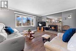 Beautiful spacious living room with wood burning fireplace.  Virtually staged fire. Large window brings in lots of light into this space. - 