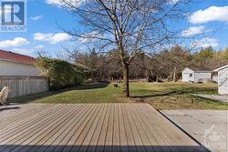 Extra large deck to sit out and relax on those hot summer days.  Backing onto wooded area. - 