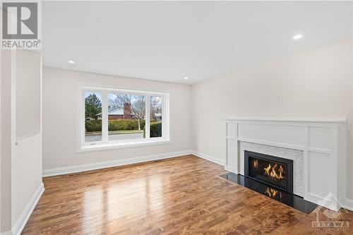 Living room features a gas fireplace. Beautiful hardwood floors. Picturesque window. - 1235 Parkway Drive, Ottawa, ON - Indoor Photo Showing Living Room With Fireplace