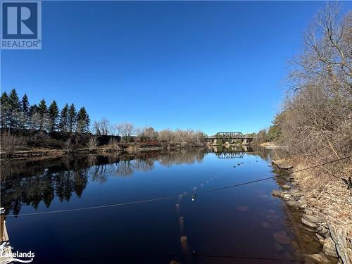 View down the Muskoka River - 31 Dairy Lane Unit# 102, Huntsville, ON - Outdoor With Body Of Water With View