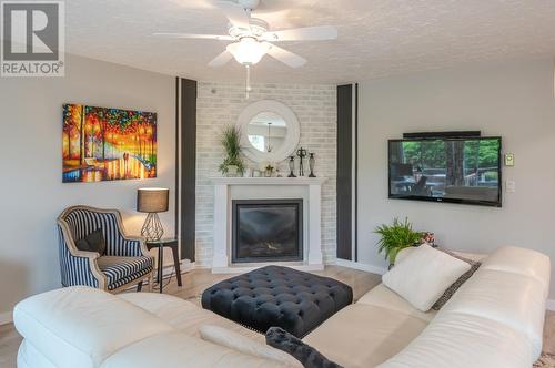 22 Abbott Street Unit# 104, Penticton, BC - Indoor Photo Showing Living Room With Fireplace