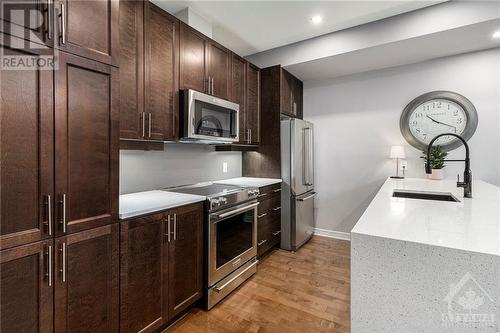 Main level kitchen with quartz counters, stainless steel appliances, shaker cupboard doors - 129 Eye Bright Crescent, Ottawa, ON - Indoor Photo Showing Kitchen