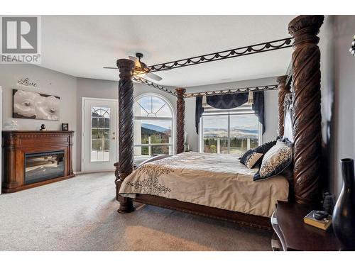 5795 Dixon Dam Road, Vernon, BC - Indoor Photo Showing Bedroom With Fireplace