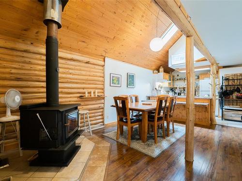 1029 Englishman River Rd, Errington, BC - Indoor Photo Showing Dining Room With Fireplace