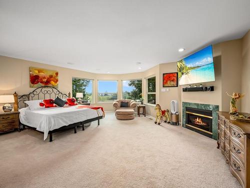 2201 Sea Lion Way, Courtenay, BC - Indoor Photo Showing Bedroom With Fireplace