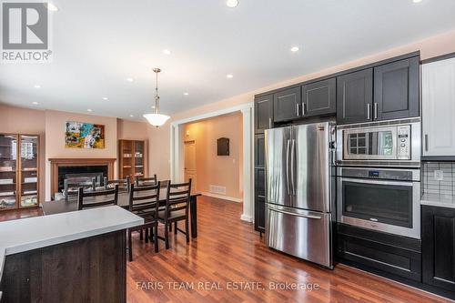 19 Castleton Dr, Tiny, ON - Indoor Photo Showing Kitchen With Fireplace With Upgraded Kitchen