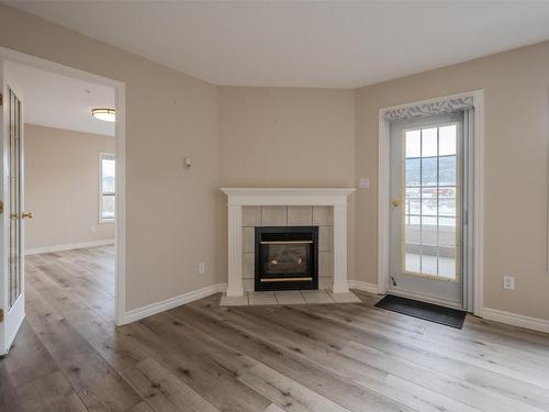 704-2245 Atkinson Street, Penticton, BC - Indoor Photo Showing Living Room With Fireplace