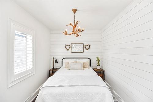 The primary bedroom walk-in closet was converted to small bedroom with chip lath accent walls. This room would make a perfect nursery! It's also a nice escape when your spouse snores! - 1423 Nebo Road, Hannon, ON - Indoor Photo Showing Bedroom
