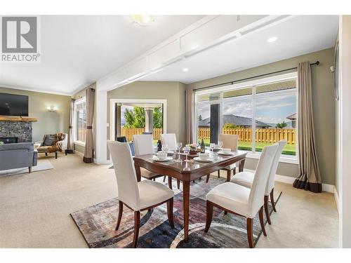 470 Trumpeter Road, Kelowna, BC - Indoor Photo Showing Dining Room With Fireplace