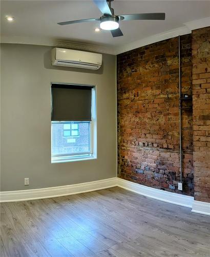 Pimary Bedroom with exposed brick - 274 King Street W|Unit #1, Hamilton, ON - Indoor Photo Showing Other Room
