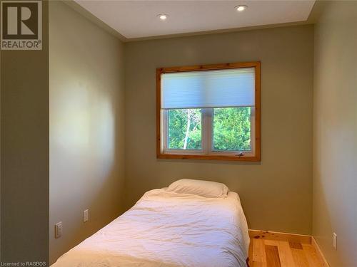 This cozy 3rd bedroom has a lovely window. - 34 Hatt Street, Northern Bruce Peninsula, ON - Indoor Photo Showing Bedroom