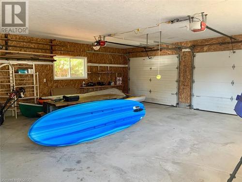 Large 26ft x 24ft garage area is finished with insulated double overhead doors with openers. Great to store cars, boats & cottage toys! - 34 Hatt Street, Northern Bruce Peninsula, ON - Indoor Photo Showing Garage