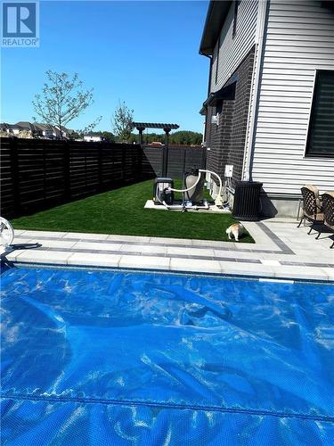 Pool and side yard w/artificial turf - 165 Finsbury Avenue, Stittsville, ON - Outdoor With In Ground Pool