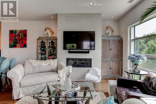 #203 -1705 Fiddlehead Pl, London, ON - Indoor Photo Showing Living Room With Fireplace