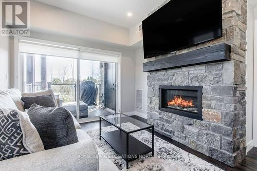 #107 -11 Beausoleil Lane, Blue Mountains, ON - Indoor Photo Showing Living Room With Fireplace