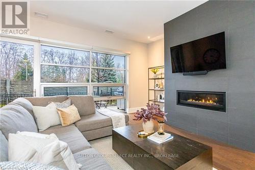 #100 -1705 Fiddlehead Pl, London, ON - Indoor Photo Showing Living Room With Fireplace