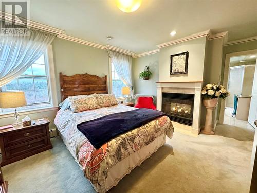 18 Vatcher Place, Gander, NL - Indoor Photo Showing Bedroom With Fireplace