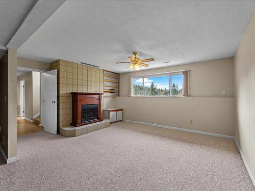 1276 Rio Drive, Kelowna, BC - Indoor With Fireplace