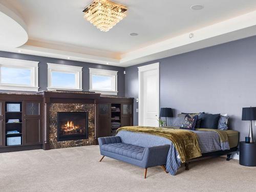 4040 Casorso Road, Kelowna, BC - Indoor Photo Showing Bedroom With Fireplace