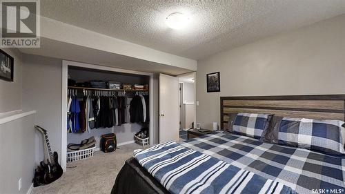 15 Frere Street, Kindersley, SK - Indoor Photo Showing Bedroom With Fireplace