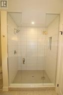Tiled ensuite shower photo from previous unit by seller - 